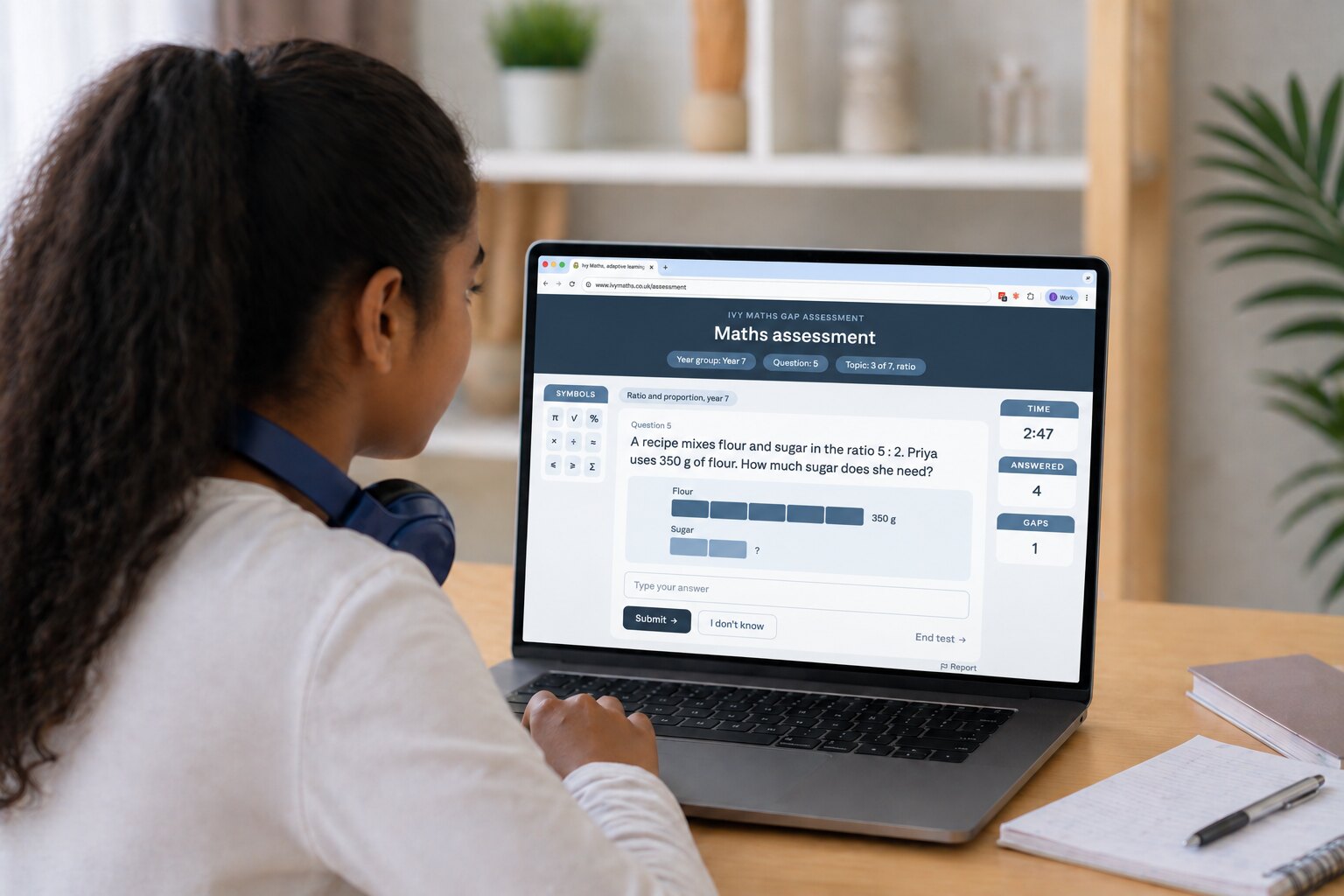 A student at a laptop, answering a question in the maths assessment